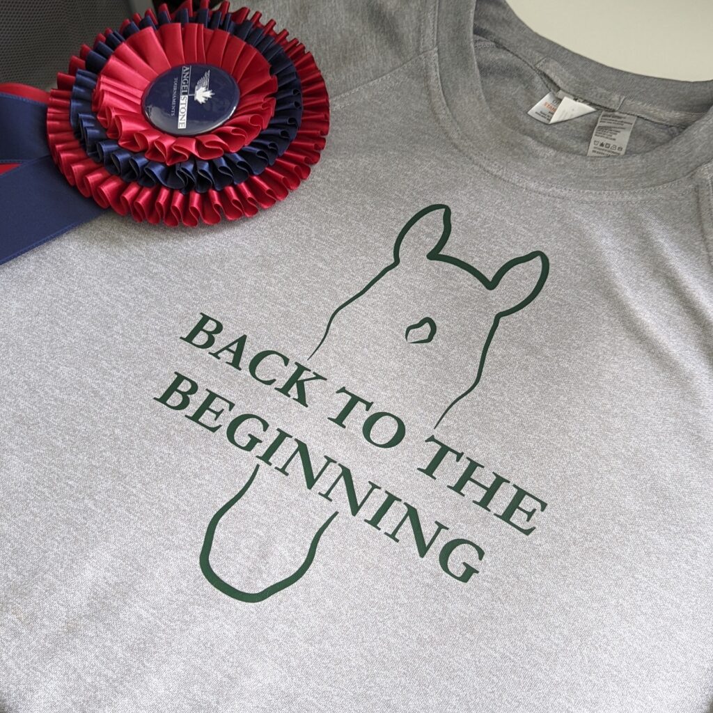 Grey sweater with a horse head outline with show name in heat transfer.